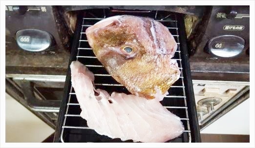 鯛の表面に塩を振りかけて焼いていく